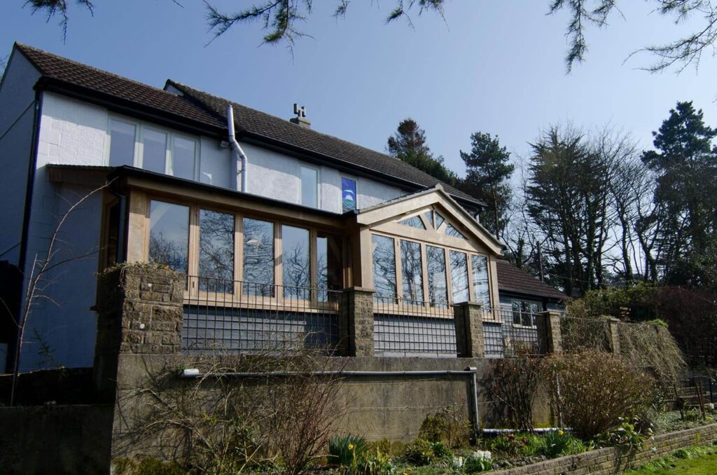 Oak timber framed extension in Morcombelake with double-glazed windows and doors